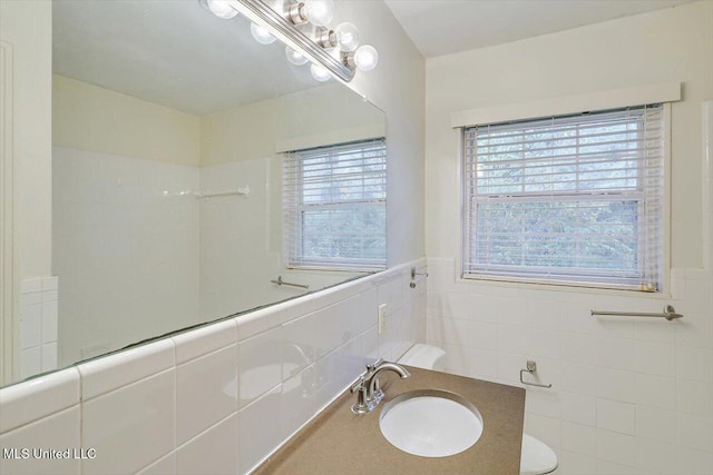 bathroom with tile walls and vanity