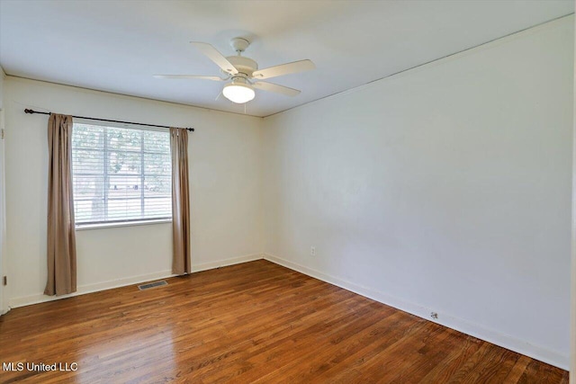 spare room with hardwood / wood-style flooring and ceiling fan