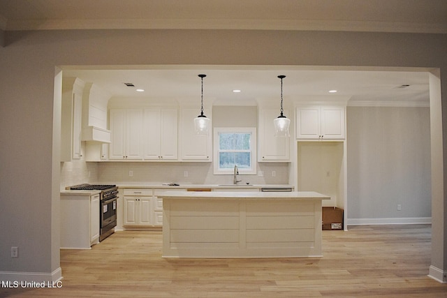 kitchen featuring a center island, white cabinetry, high end stainless steel range oven, and hanging light fixtures