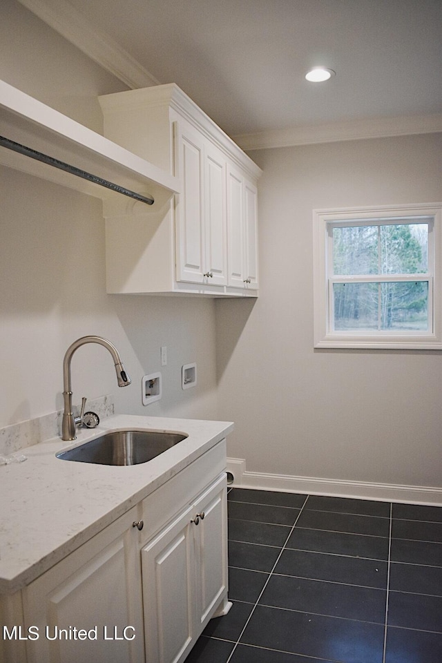 clothes washing area featuring sink, cabinets, crown molding, hookup for a washing machine, and dark tile patterned flooring