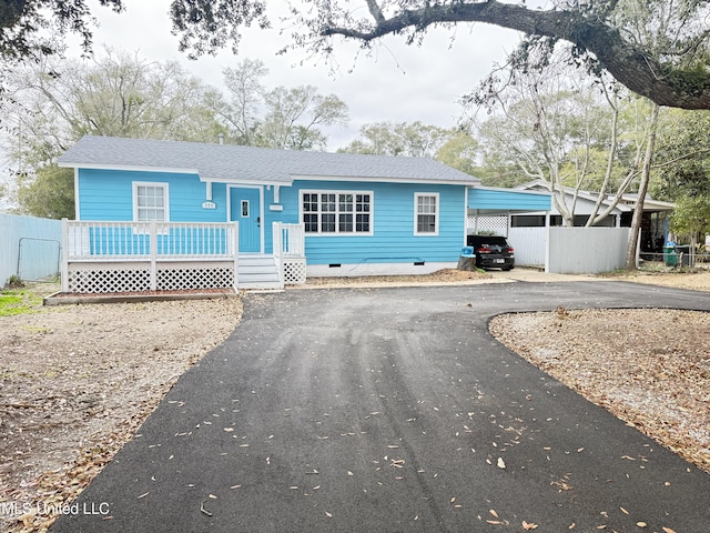 ranch-style house featuring a carport