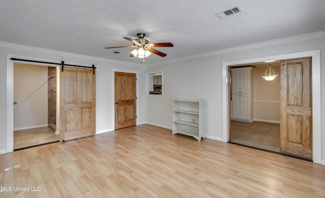 315 Church St, Madison, MS 39110 - unfurnished bedroom with a barn door, light wood-style floors, crown molding, baseboards, and a ceiling fan