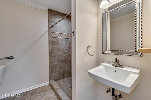 315 Church St, Madison, MS 39110 - bathroom featuring crown molding, a tile shower, toilet, a sink, and baseboards