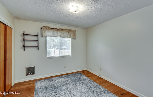 315 Church St, Madison, MS 39110 - spare room featuring wood finished floors, a textured ceiling, and baseboards