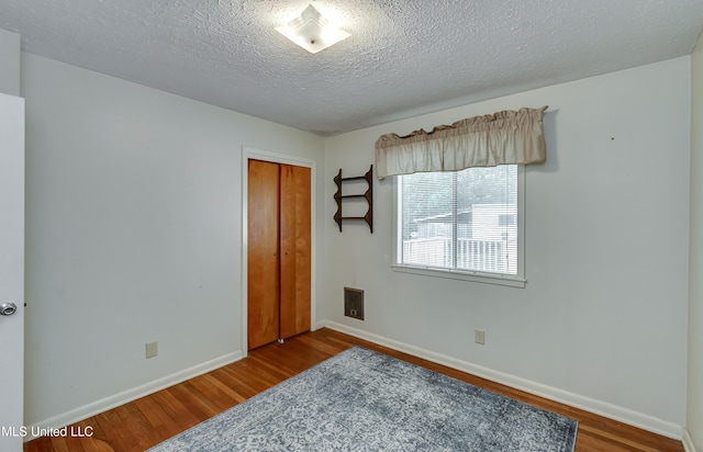 315 Church St, Madison, MS 39110 - bedroom featuring wood finished floors, a closet, baseboards, and a textured ceiling