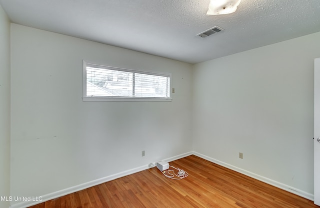 315 Church St, Madison, MS 39110 - empty room featuring baseboards, wood finished floors, and a textured ceiling
