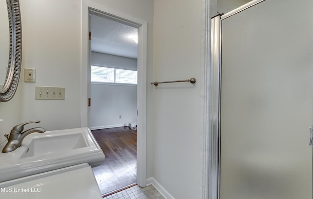 315 Church St, Madison, MS 39110 - full bathroom with a sink, a stall shower, baseboards, and a textured ceiling