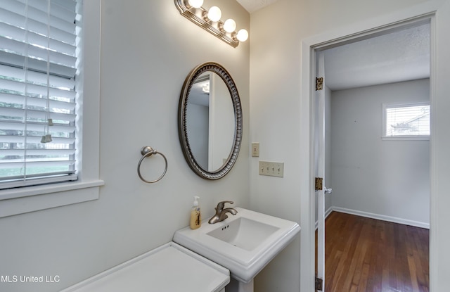 315 Church St, Madison, MS 39110 - bathroom featuring wood finished floors, baseboards, and a sink