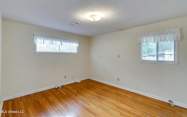 315 Church St, Madison, MS 39110 - spare room featuring plenty of natural light, a textured ceiling, baseboards, and light wood-type flooring