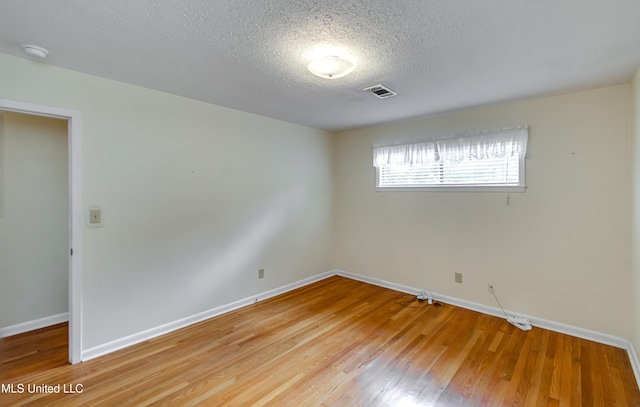 315 Church St, Madison, MS 39110 - unfurnished room with a textured ceiling, baseboards, light wood-type flooring, and a smoke detector