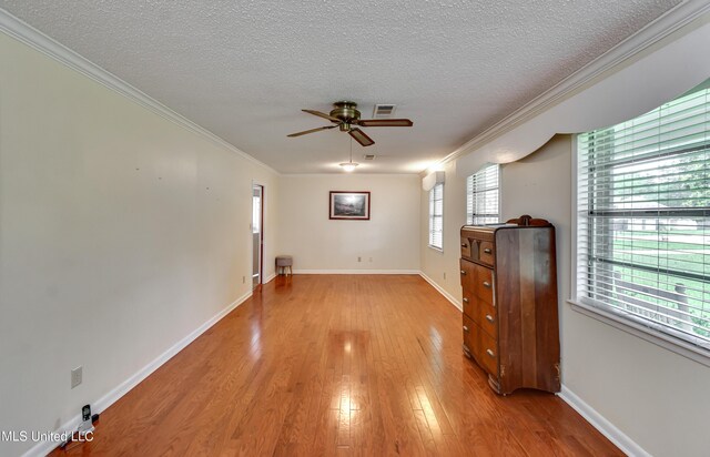 315 Church St, Madison, MS 39110 - empty room featuring ornamental molding, a textured ceiling, a ceiling fan, light wood-type flooring, and baseboards