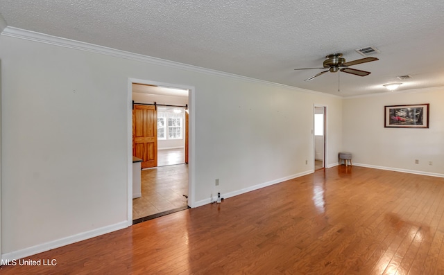 315 Church St, Madison, MS 39110 - empty room with hardwood / wood-style flooring, plenty of natural light, a textured ceiling, ornamental molding, and a ceiling fan