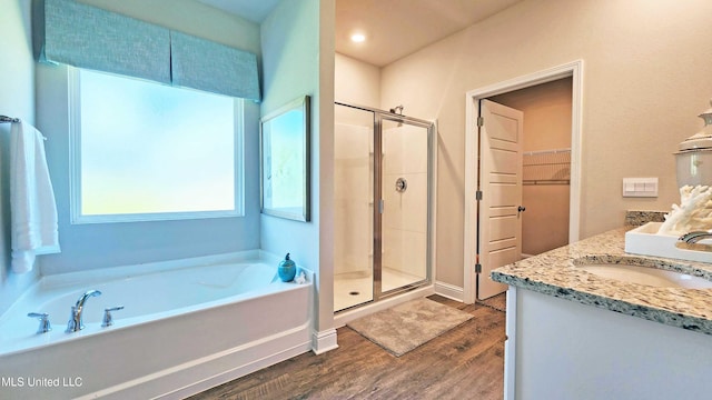 15109 Windmill Ridge Parkway, Diberville, MS 39540 - bathroom with wood finished floors, a stall shower, a garden tub, double vanity, and a walk in closet