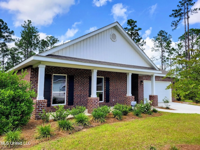 15109 Windmill Ridge Parkway, Diberville, MS 39540 - view of front of home featuring brick siding, covered porch, driveway, a garage, and a front lawn