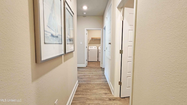 15109 Windmill Ridge Parkway, Diberville, MS 39540 - corridor featuring washer and dryer, wood finished floors, and a textured wall