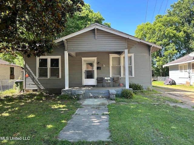 bungalow-style house featuring a front yard