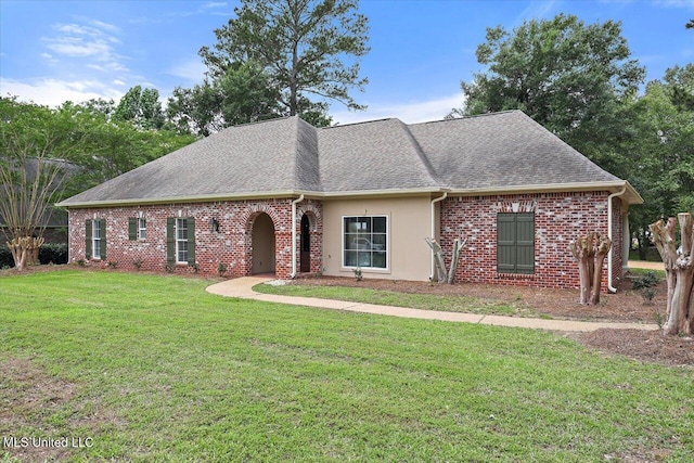 207 Keystone Pl, Brandon, MS 39042 - view of front of house with a shingled roof, a front lawn, stucco siding, and brick siding