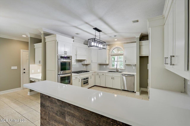 207 Keystone Pl, Brandon, MS 39042 - kitchen with appliances with stainless steel finishes, tasteful backsplash, ornamental molding, light tile patterned floors, and white cabinetry