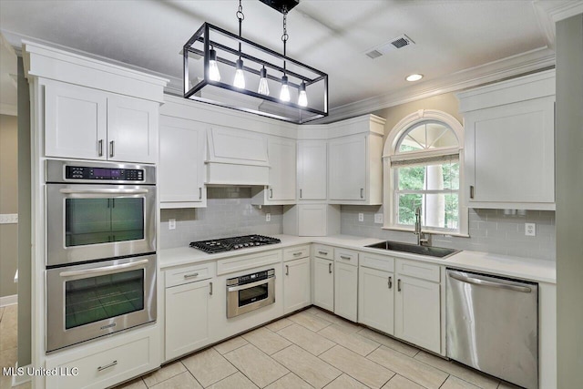 207 Keystone Pl, Brandon, MS 39042 - kitchen with a sink, stainless steel appliances, crown molding, light countertops, and backsplash
