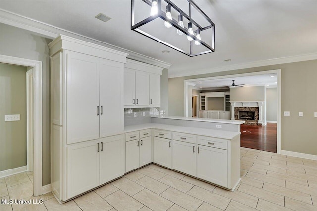 207 Keystone Pl, Brandon, MS 39042 - kitchen with light countertops, ornamental molding, ceiling fan, a premium fireplace, and decorative backsplash