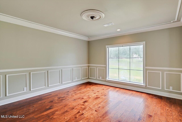 207 Keystone Pl, Brandon, MS 39042 - spare room featuring crown molding, wood finished floors, wainscoting, and a decorative wall