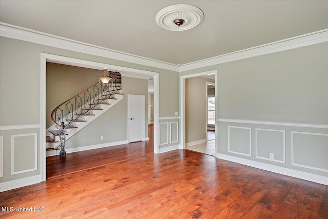 207 Keystone Pl, Brandon, MS 39042 - unfurnished room with stairway, crown molding, wood finished floors, and a decorative wall