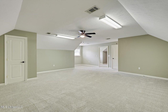 207 Keystone Pl, Brandon, MS 39042 - bonus room with vaulted ceiling, ceiling fan, light colored carpet, baseboards, and a textured ceiling