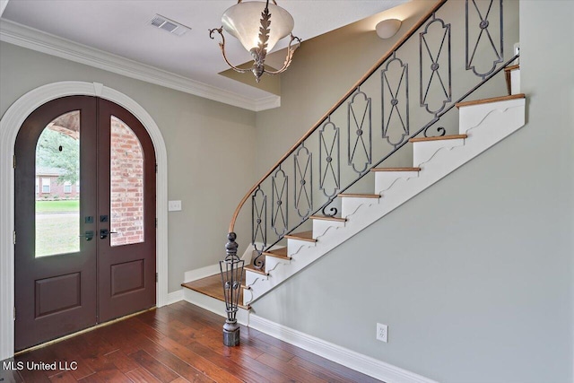 207 Keystone Pl, Brandon, MS 39042 - foyer entrance featuring arched walkways, hardwood / wood-style flooring, a chandelier, baseboards, and stairway