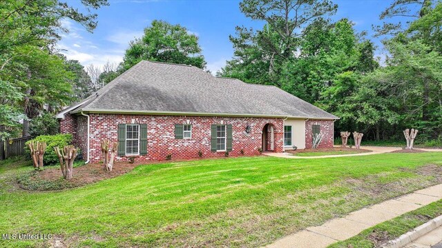 207 Keystone Pl, Brandon, MS 39042 - view of front of house featuring a front lawn, a shingled roof, and brick siding