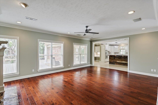 207 Keystone Pl, Brandon, MS 39042 - unfurnished living room with ceiling fan, baseboards, plenty of natural light, ornamental molding, and a textured ceiling