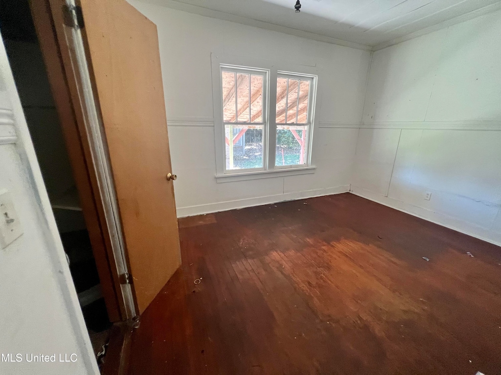 empty room with dark wood-type flooring