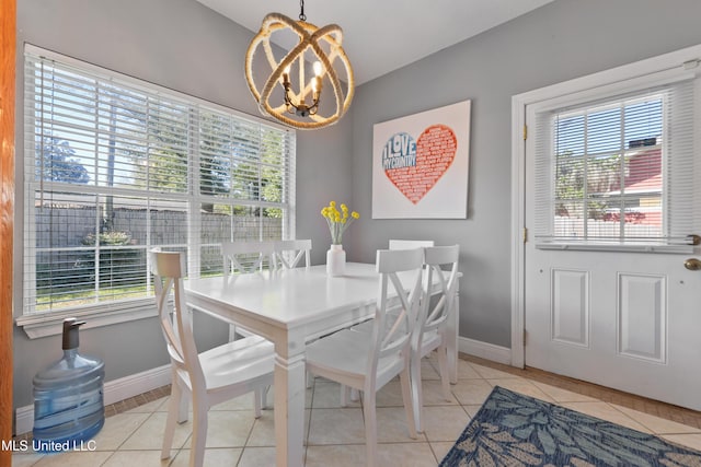 dining space featuring light tile patterned floors, a chandelier, and a wealth of natural light