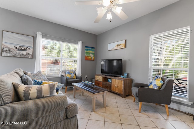 living area featuring a ceiling fan and light tile patterned flooring