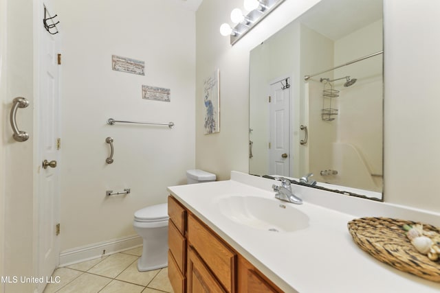 bathroom with toilet, vanity, baseboards, and tile patterned floors