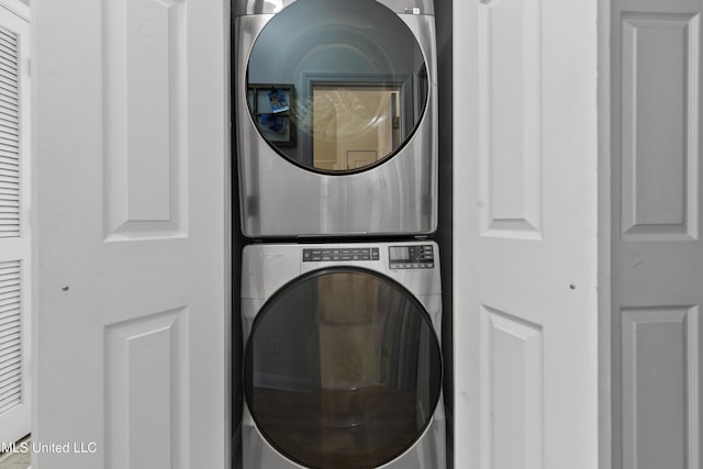 laundry area with stacked washer and dryer and laundry area