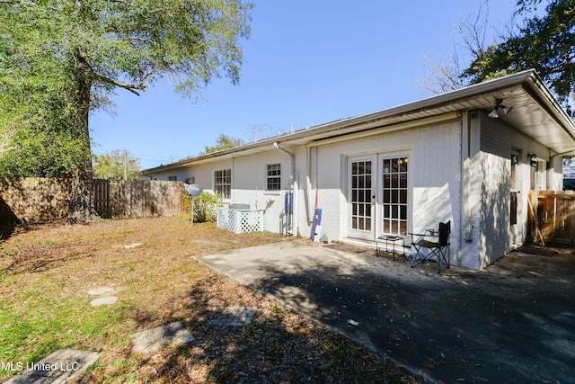 back of property with a patio and fence