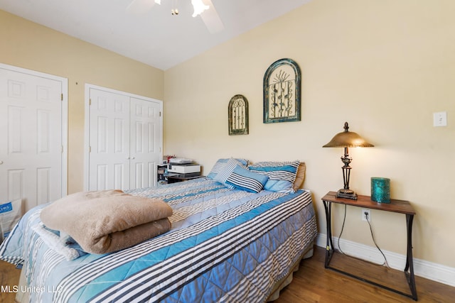 bedroom featuring a closet, wood finished floors, a ceiling fan, and baseboards