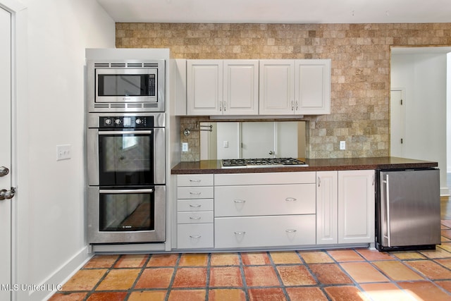 kitchen with white cabinetry and appliances with stainless steel finishes