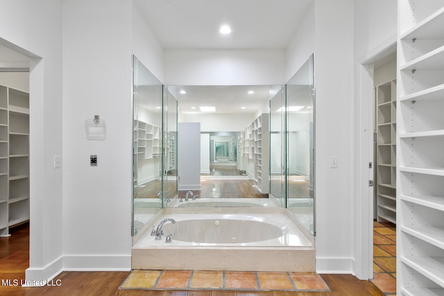 bathroom featuring a bathing tub and hardwood / wood-style flooring