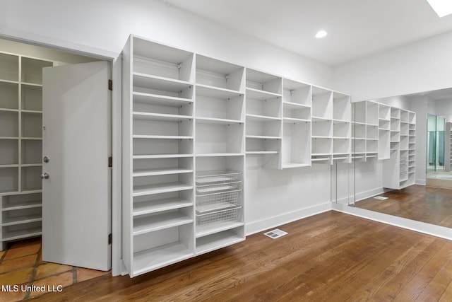 walk in closet featuring hardwood / wood-style flooring