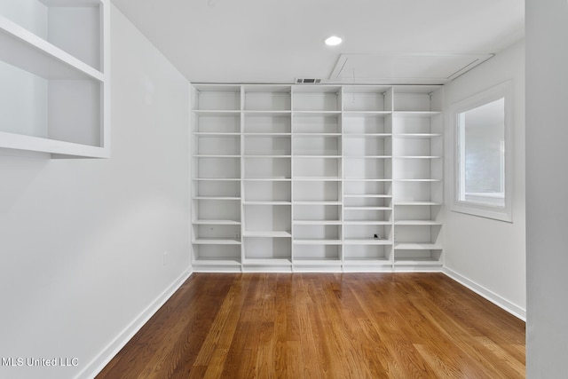 spacious closet featuring hardwood / wood-style floors