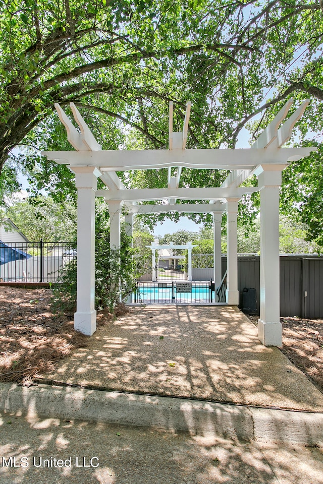 view of patio featuring a pergola and a fenced in pool