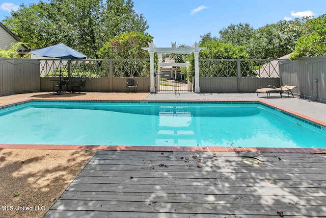 view of swimming pool featuring a deck