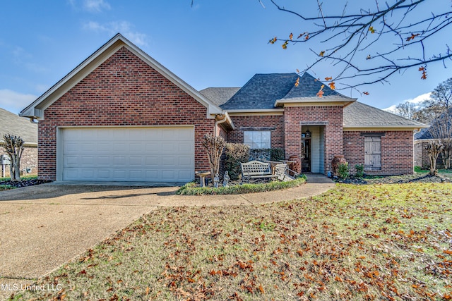 view of front of house featuring a garage and a front lawn