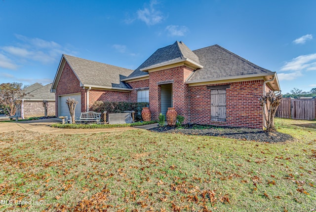 view of front facade with a front yard and a garage