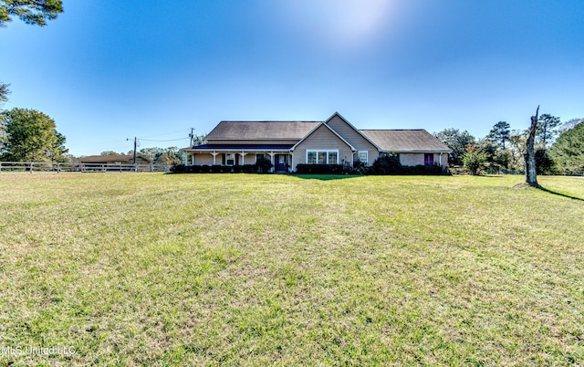 ranch-style home featuring a front lawn