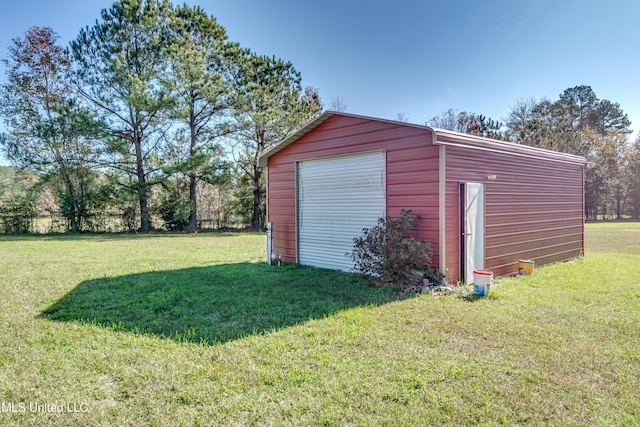 view of outdoor structure with a lawn and a garage