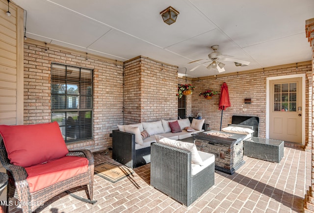 view of patio with an outdoor living space with a fire pit and ceiling fan