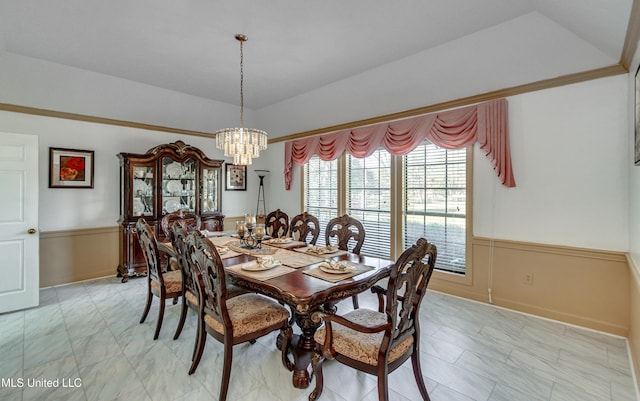 dining area with a tray ceiling and a chandelier