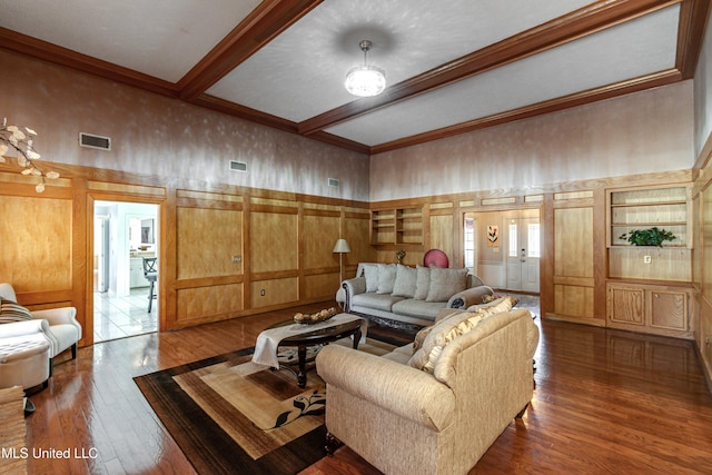 living room with beamed ceiling, ornamental molding, a high ceiling, and hardwood / wood-style flooring